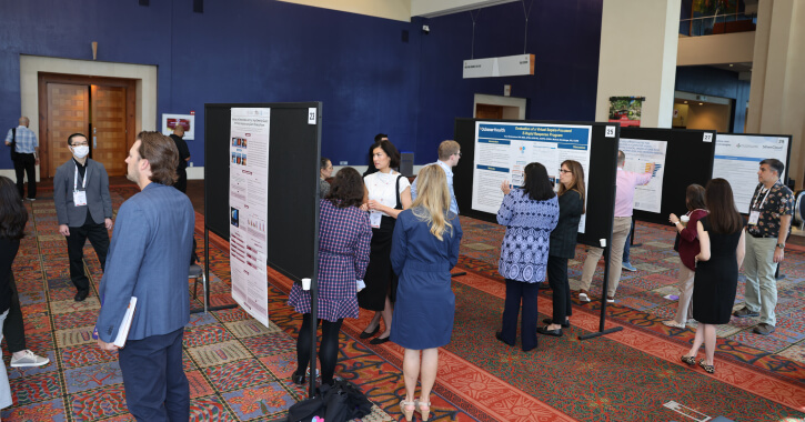 Attendees take in research poster presentations during the 2022 event